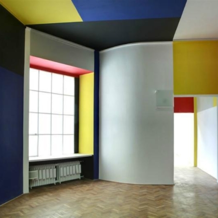Sala Neoplastyczna, drewniana podłoga, ściany pomalowane w kolorach niebieskim, czerwonym, żółtym, białym i czarnym