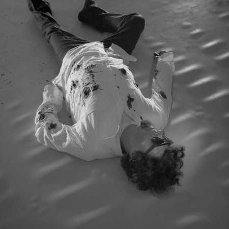 Man lying on the floor in white shirt 