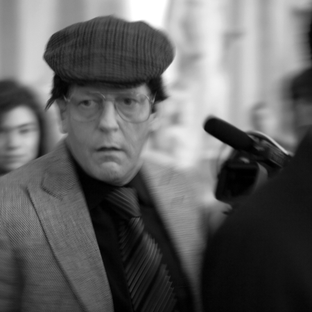 Jan Fabre in a hat surrounded by people