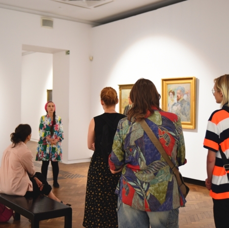a group of people taking a tour of the exhibition space