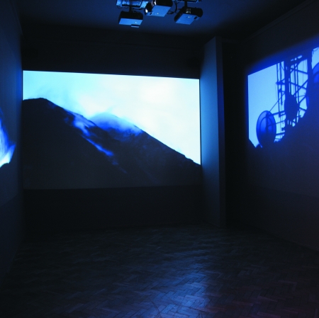exhibition view with films displayed on the walls 