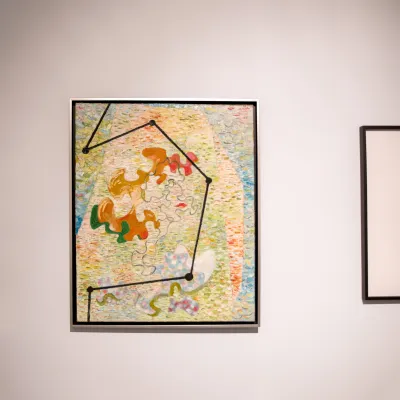 A colorful picture hung on a white wall